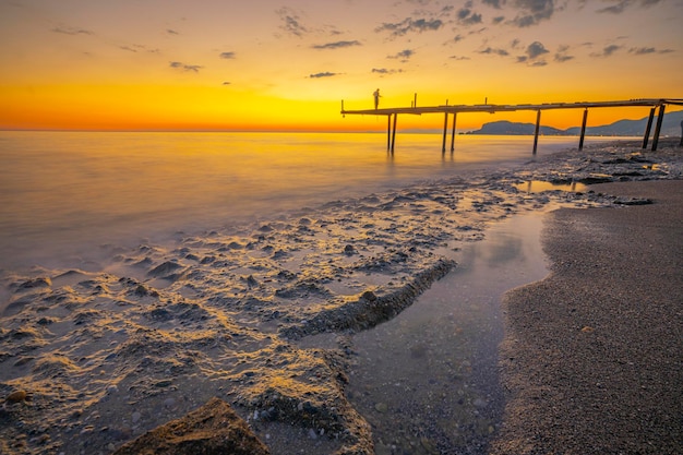 pier and sea meeting with sunset