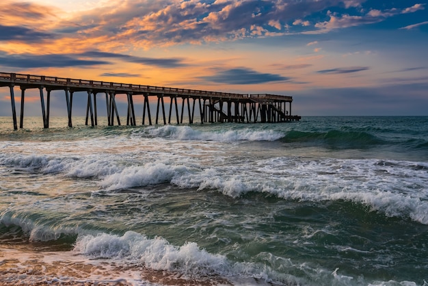 Pier at sunset, wavy beautiful sea