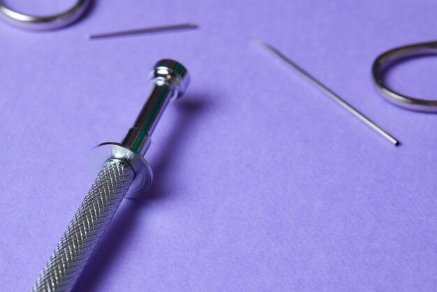 Piercing earrings closeup On a Violet background