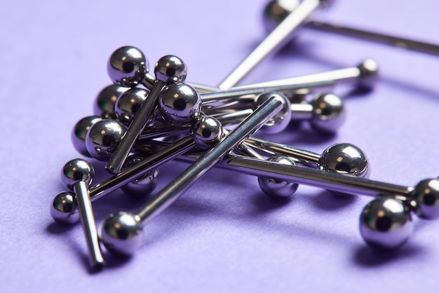 Piercing earrings closeup on a violet background