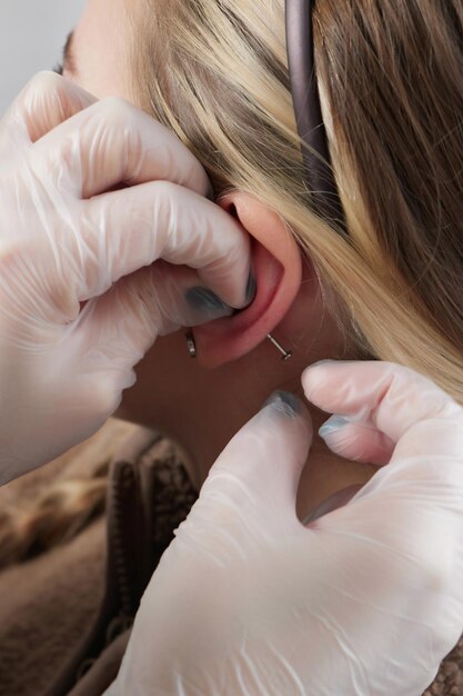 Piercings on an ear Conch and helix piercings close up