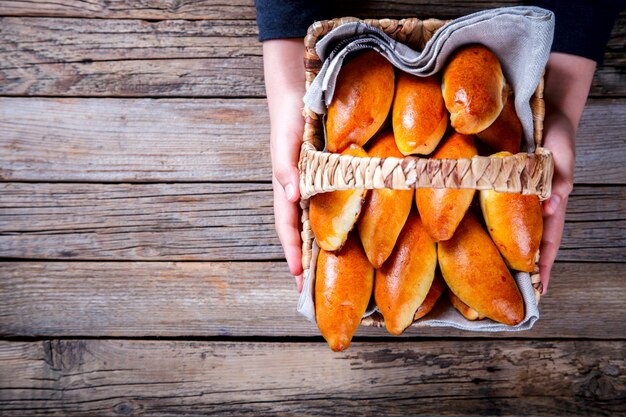 Pies in the Basket in the hands of a child.Filling Jam Berries and Fruit.Cakes home.Dessert.Copy space for Text