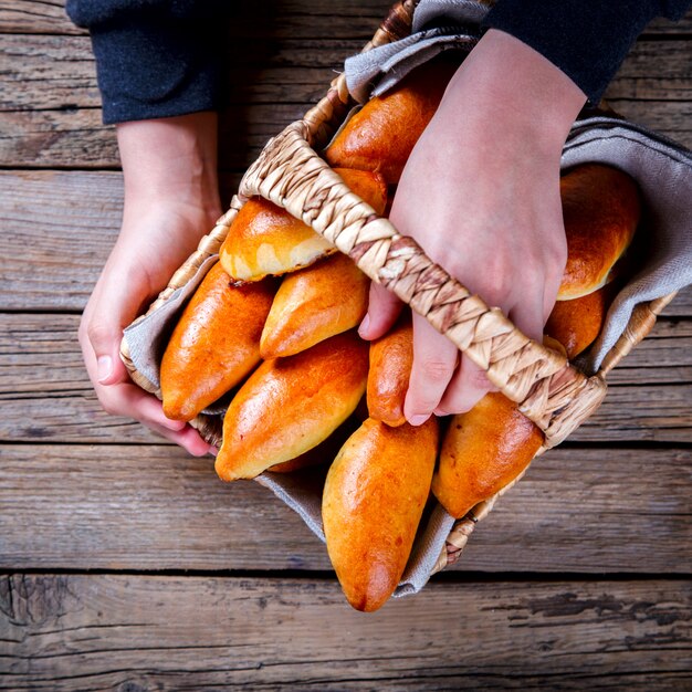 Pies in the Basket in the hands of a child