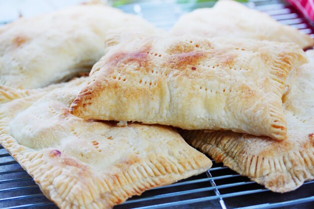 Pies stuffed with apples on a grill