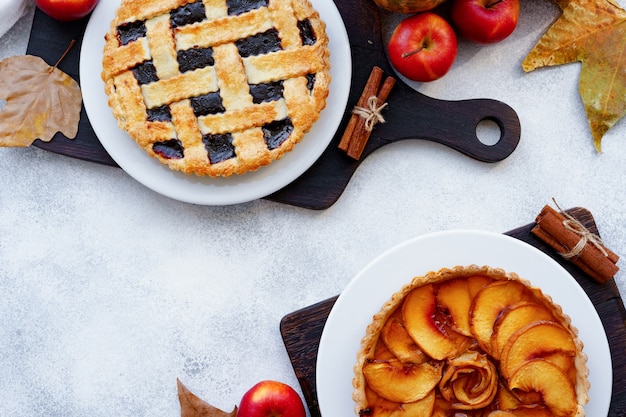 Pies with berries and apples on plates