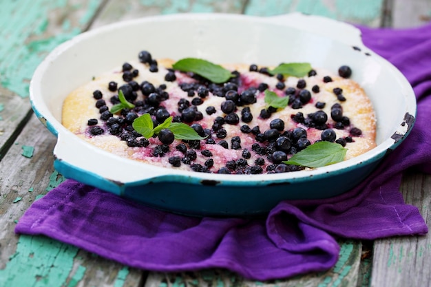 Pies with blueberries and mint, top view