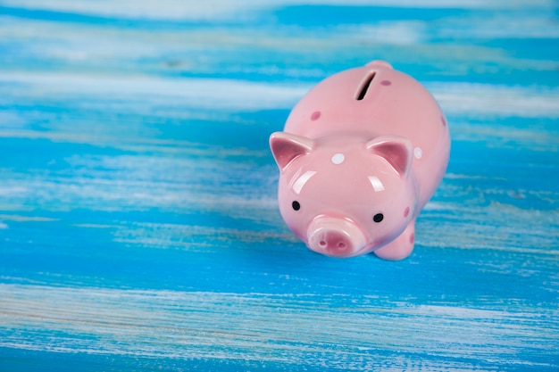 Piggy bank on a blue wooden table
