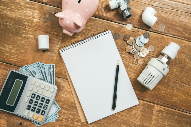 Piggy bank and calculator with Heating System on table