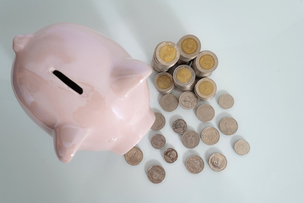 Piggy bank and coin on black background