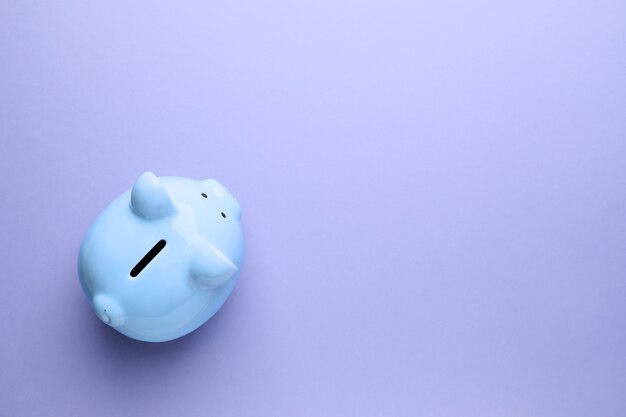 Piggy bank on color surface