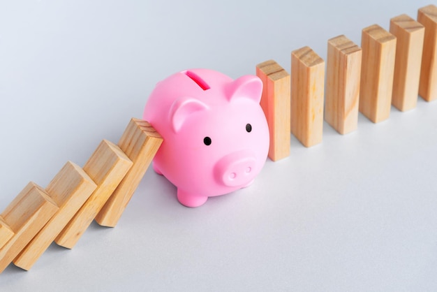 Piggy Bank and Domino Effect Business and finance concept