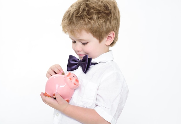 Piggy bank finance bank advertising safety money concept little smiling boy put coin in piggy bank