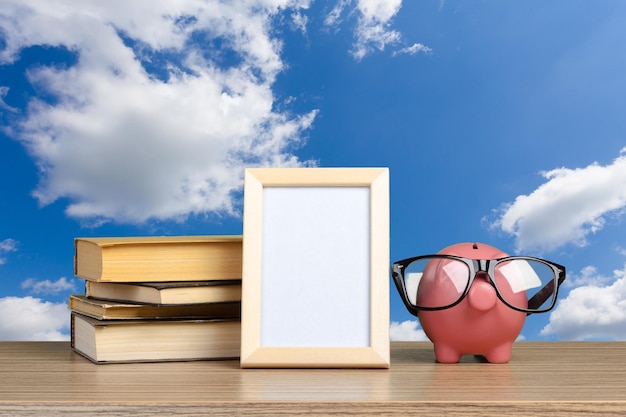 Photo piggy bank in glasses with books
