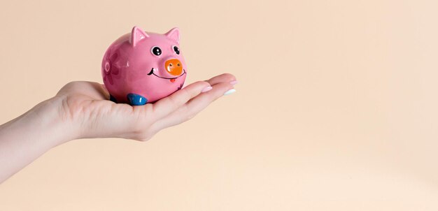 Piggy bank on his hand