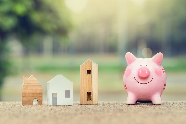 Piggy bank and house model for finance and banking concept