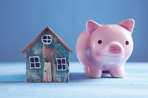 Piggy bank and house on the table