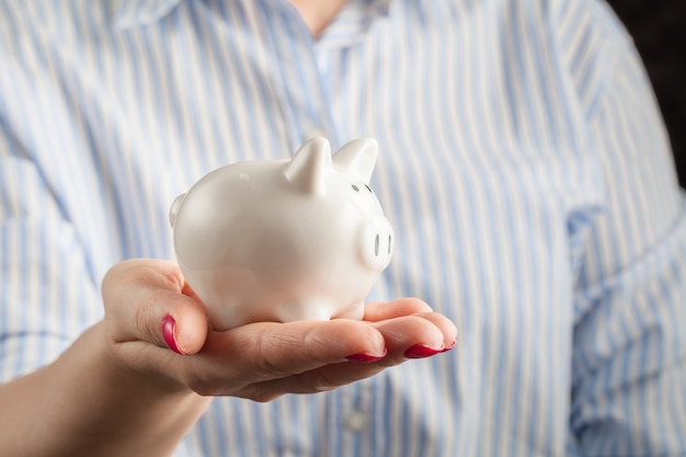 Piggy bank in a human hand