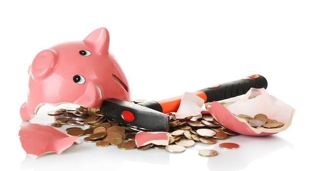 Piggy bank is broken by hammer isolated on white background