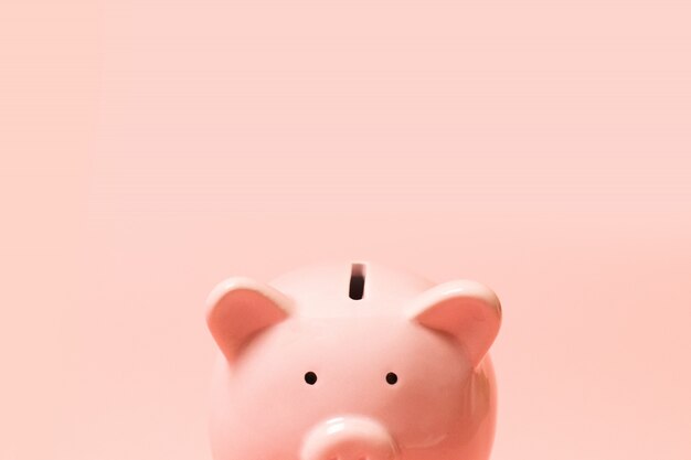 Photo piggy bank on living coral background. commercial concept.
