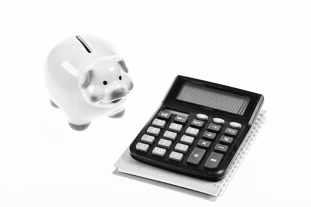 Piggy bank pink pig and calculator Exchange rates Economics and business administration Credit debt concept Piggy bank money savings Economics and profit management Economics and finance