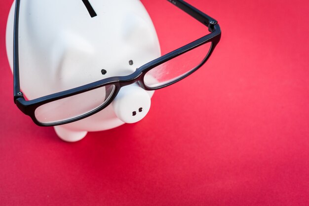 Piggy bank on red background