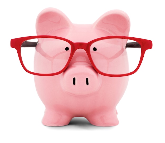 Piggy bank in red glasses on white background