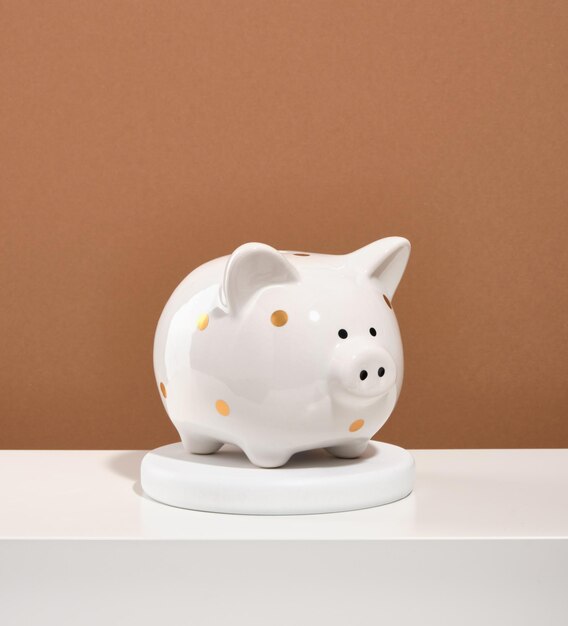 Photo piggy bank on a round stand safe deposits and savings concept