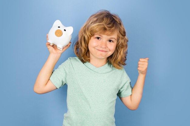 Piggy bank for saving money concept Portrait of a child with money dollars banknotes isolated over