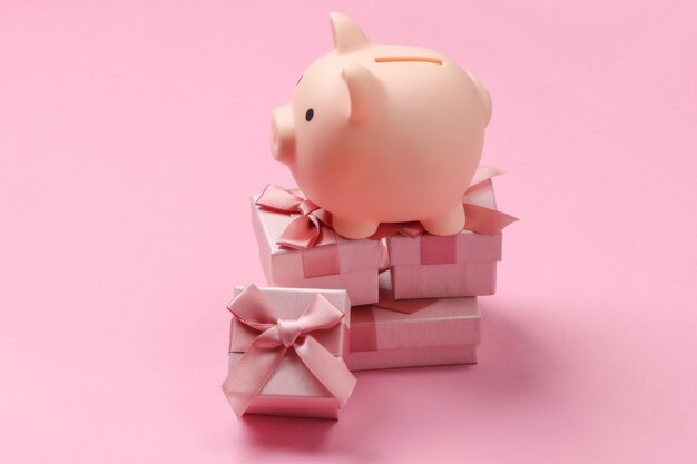 Piggy bank on stack of gift boxes