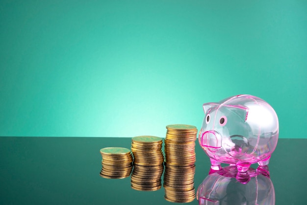 Piggy bank and stacking coins with financial concept.