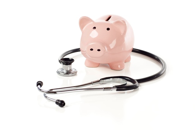 Photo piggy bank and stethoscope isolated on a white background with slight shadow