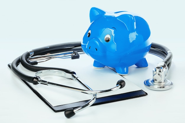 Piggy Bank and Stethoscope Isolated on a White 