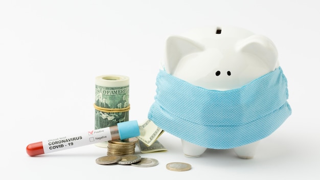 Piggy bank wearing medical mask and coronavirus test