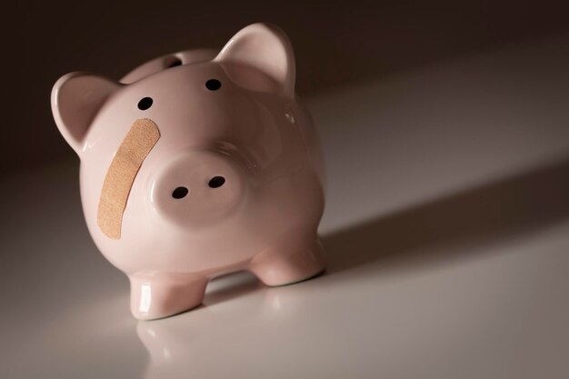 Photo piggy bank with bandage on face