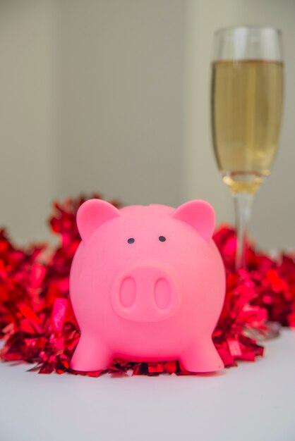 Piggy bank with Christmas decorations . piggy bank with Christmas decoration background, image for time to start saving or solution to save money for Christmas celebration holiday vacation concept.