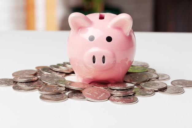 Piggy bank with coin on the table