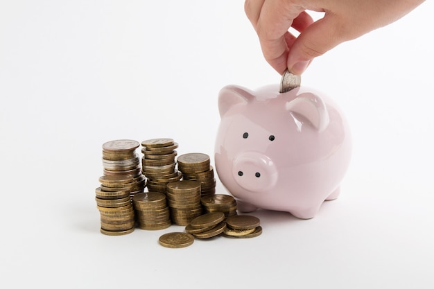 Piggy bank with coin on white background 