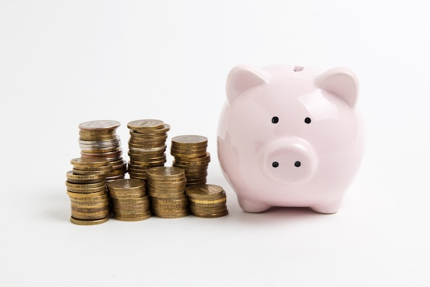 Piggy bank with coin on white background 