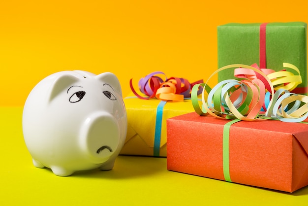 Piggy Bank with gift boxes, worried about money