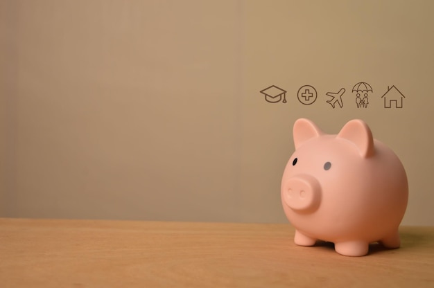 Piggy bank with home family travel health and education symbols
saving money and life expenses concept