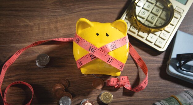 Piggy bank with measuring tape and coins