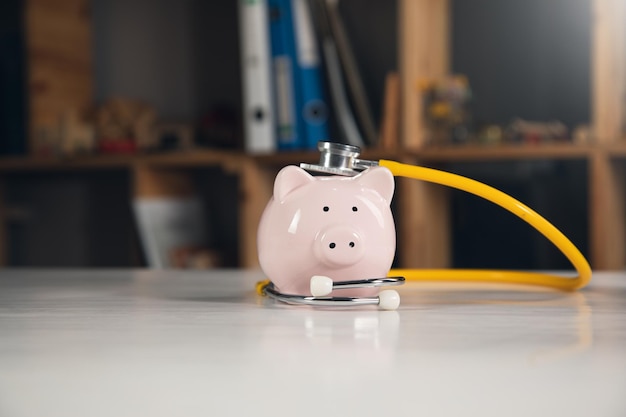 Piggy bank with stethoscope tax offset concept