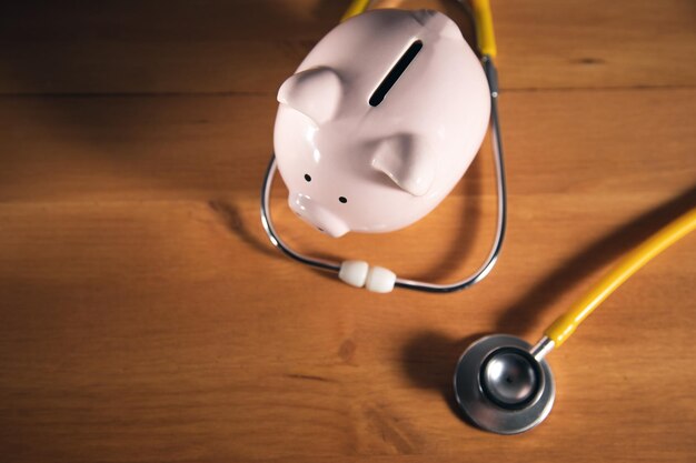 Piggy bank with stethoscope tax offset concept