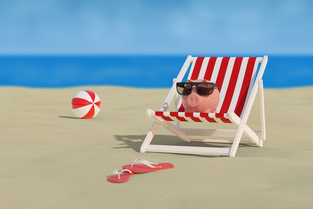 Piggy bank with sunglasses on a deck chair on the beach with the sea behind