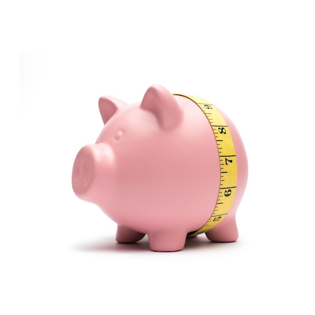 Piggy bank with tape measure on white background
