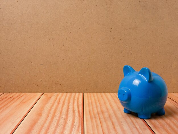 The piggy bank on wood table for earn or saving concept