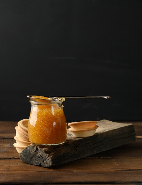 Pike caviar in a glass jar and round tartlets