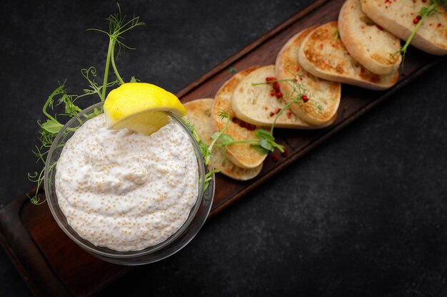 Pike caviar with toast on a wooden board