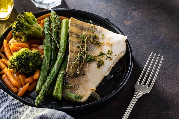 Pike perch fillet with asparagus, broccoli and carrots. 