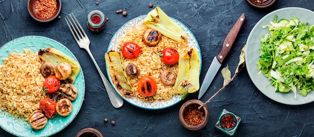 Pilaf,dish of oriental cuisine.Turkish pilaf with grilled vegetables.Pilaw in the east.Middle eastern or arabic dishes